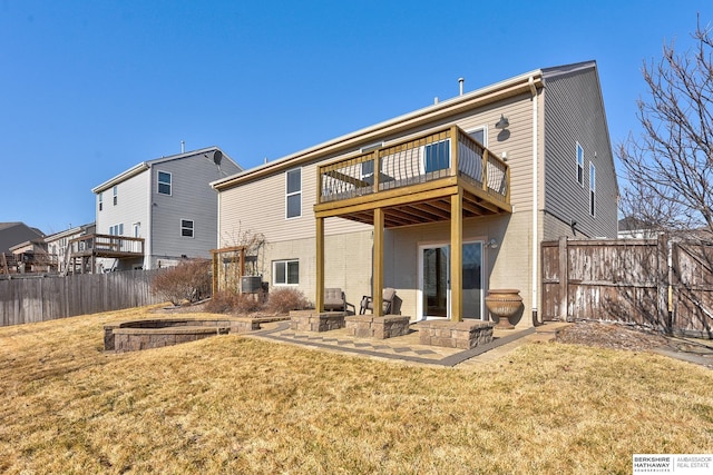 back of property featuring brick siding, central air condition unit, a lawn, and fence