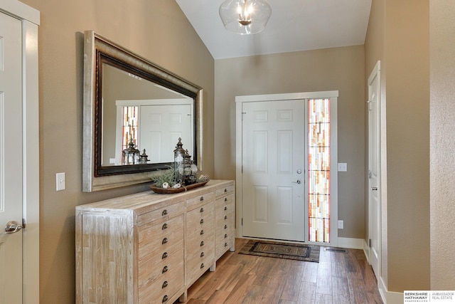 foyer featuring light wood-style flooring, baseboards, and a healthy amount of sunlight