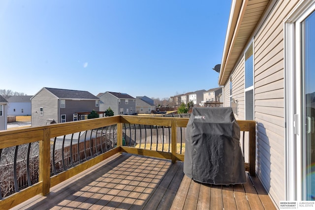 deck featuring a residential view and grilling area