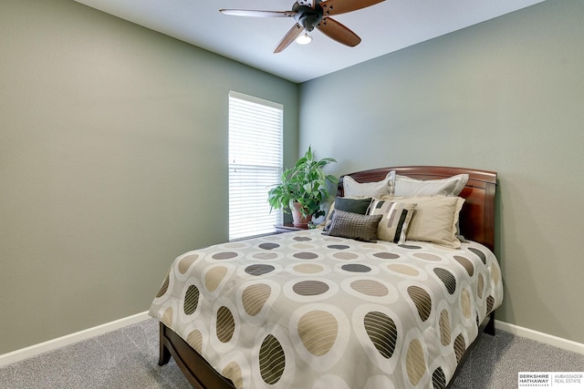 bedroom with a ceiling fan, baseboards, and carpet floors