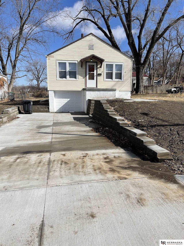 view of front of property with driveway and a garage