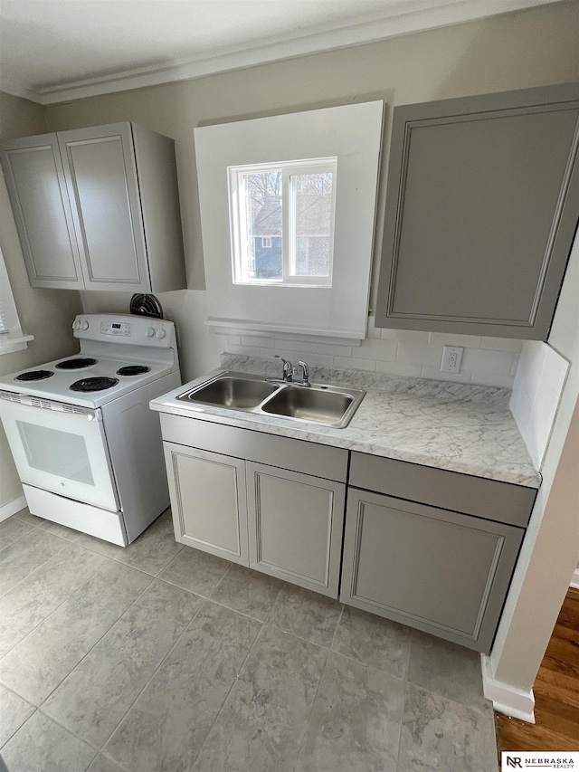 washroom featuring laundry area, ornamental molding, and a sink