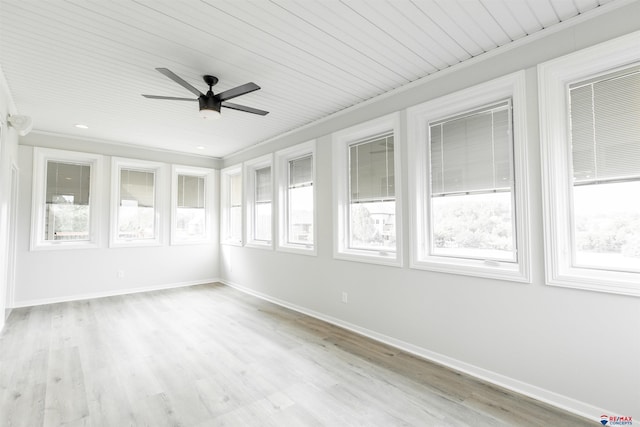 unfurnished sunroom featuring ceiling fan