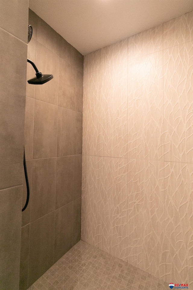 full bath with a tile shower