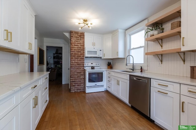 kitchen featuring a sink, backsplash, hardwood / wood-style floors, white appliances, and white cabinets