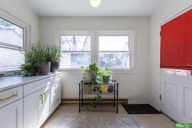 interior space with a baseboard radiator and baseboards