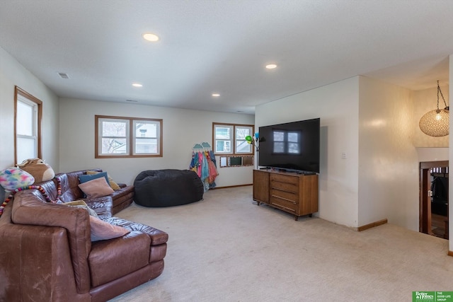 living room featuring recessed lighting, visible vents, baseboards, and light colored carpet