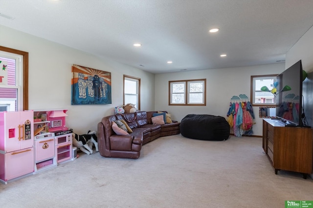 carpeted living area with recessed lighting and visible vents