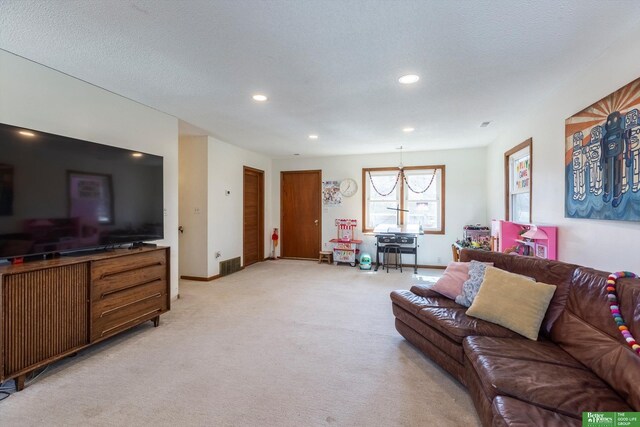 living area featuring visible vents, baseboards, a chandelier, light colored carpet, and recessed lighting