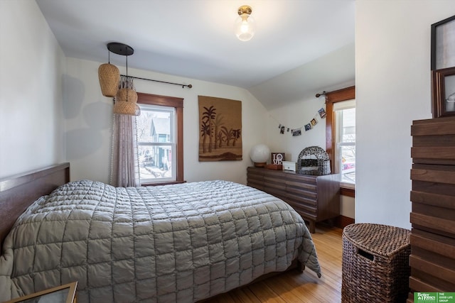 bedroom featuring lofted ceiling and light wood finished floors