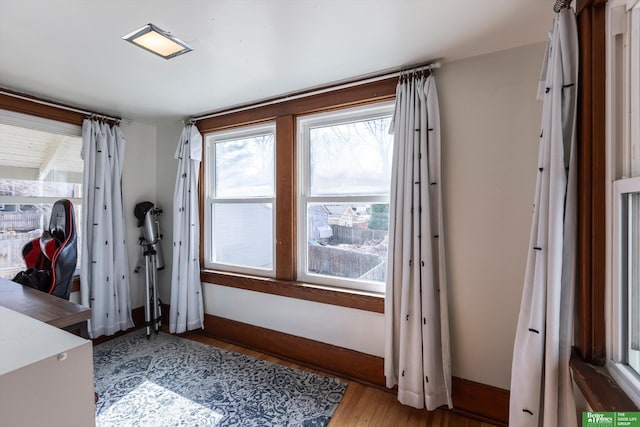 interior space featuring wood finished floors and baseboards