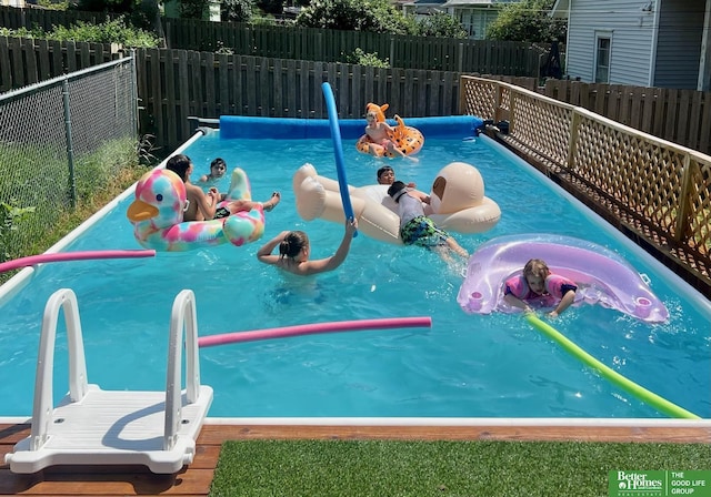 view of swimming pool featuring fence