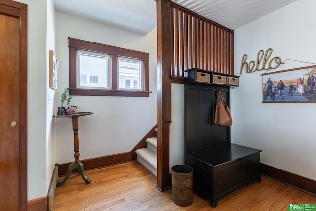 mudroom with wood finished floors and baseboards