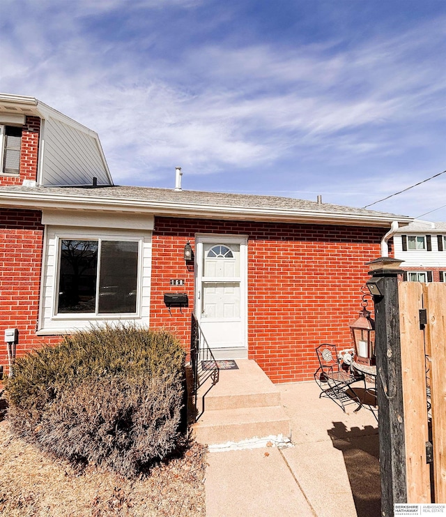 property entrance with brick siding