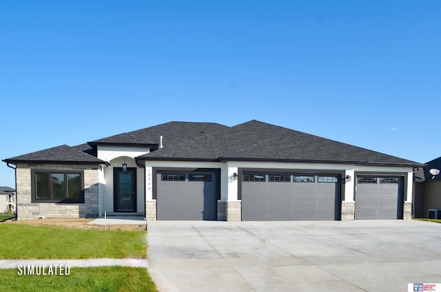 prairie-style home with concrete driveway, an attached garage, stone siding, and roof with shingles