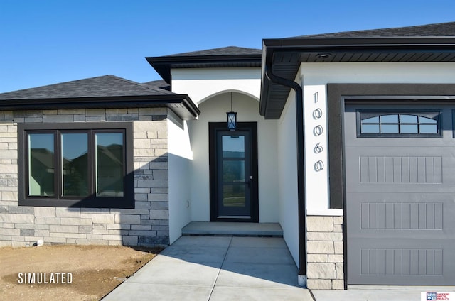 doorway to property featuring stucco siding, stone siding, and a shingled roof