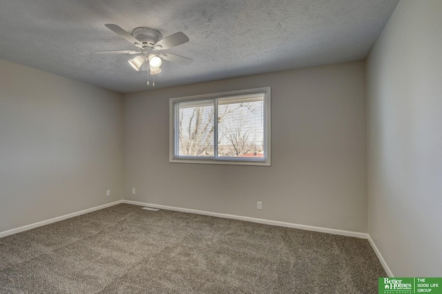 carpeted spare room with baseboards, a textured ceiling, and a ceiling fan