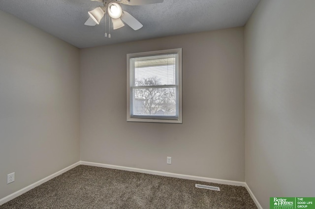 carpeted spare room featuring a textured ceiling, a ceiling fan, and baseboards