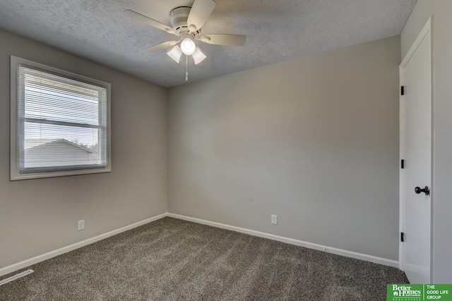 unfurnished room with a ceiling fan, baseboards, a textured ceiling, and dark carpet