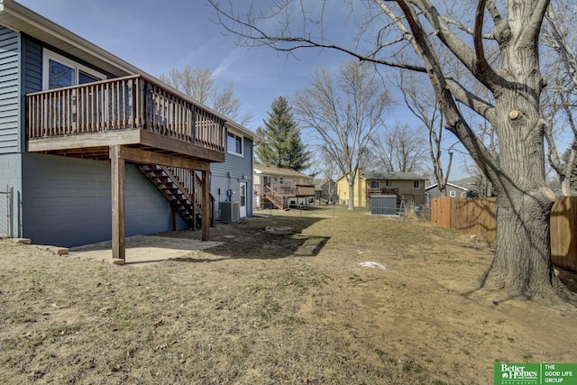 view of yard featuring stairs, a deck, cooling unit, and fence