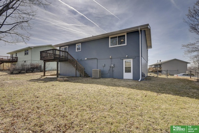 rear view of property featuring fence, stairway, a lawn, cooling unit, and a deck