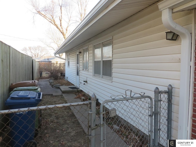 view of home's exterior with fence private yard and a gate