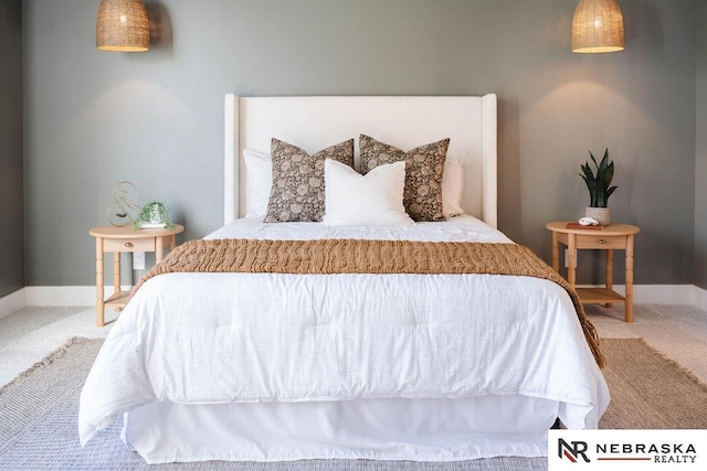 carpeted bedroom featuring baseboards