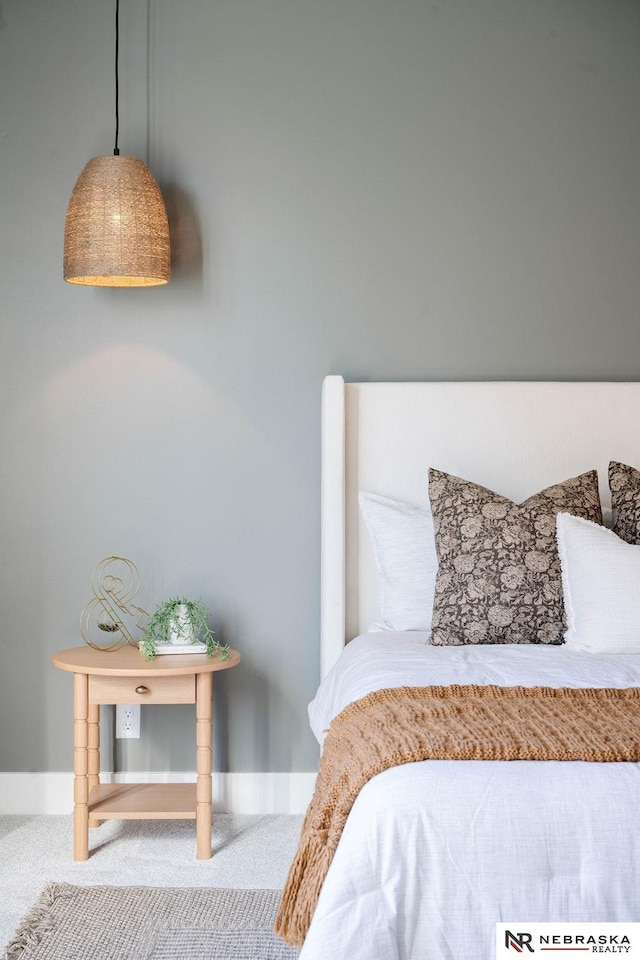 carpeted bedroom featuring baseboards