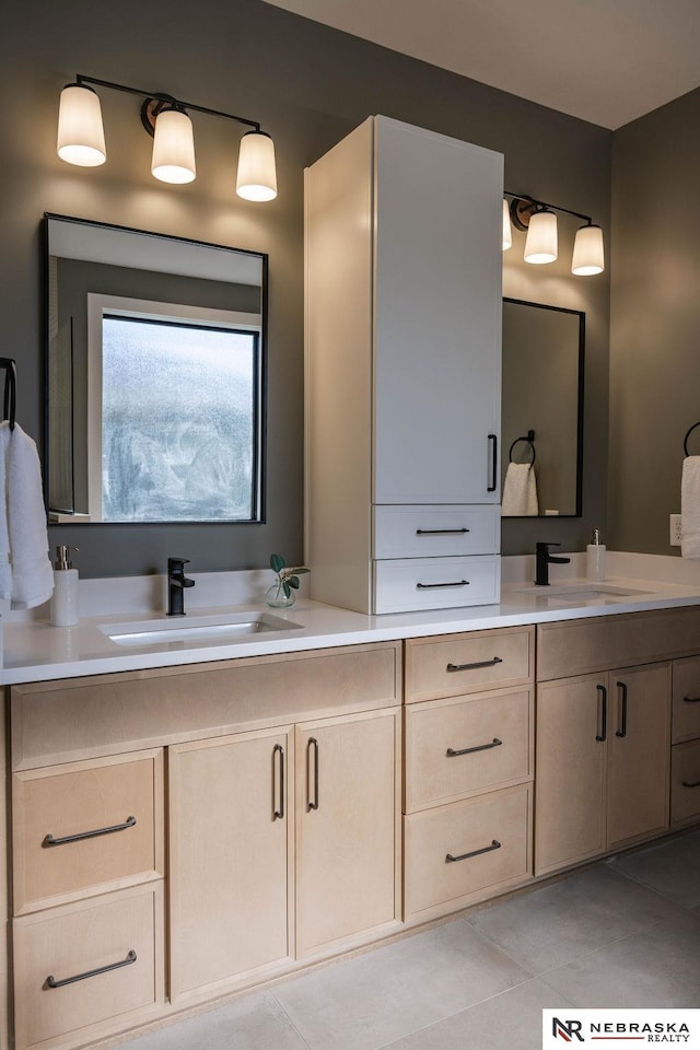 bathroom with double vanity, tile patterned floors, and a sink