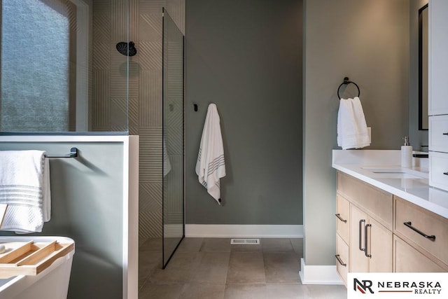 full bathroom featuring vanity, baseboards, visible vents, walk in shower, and tile patterned floors