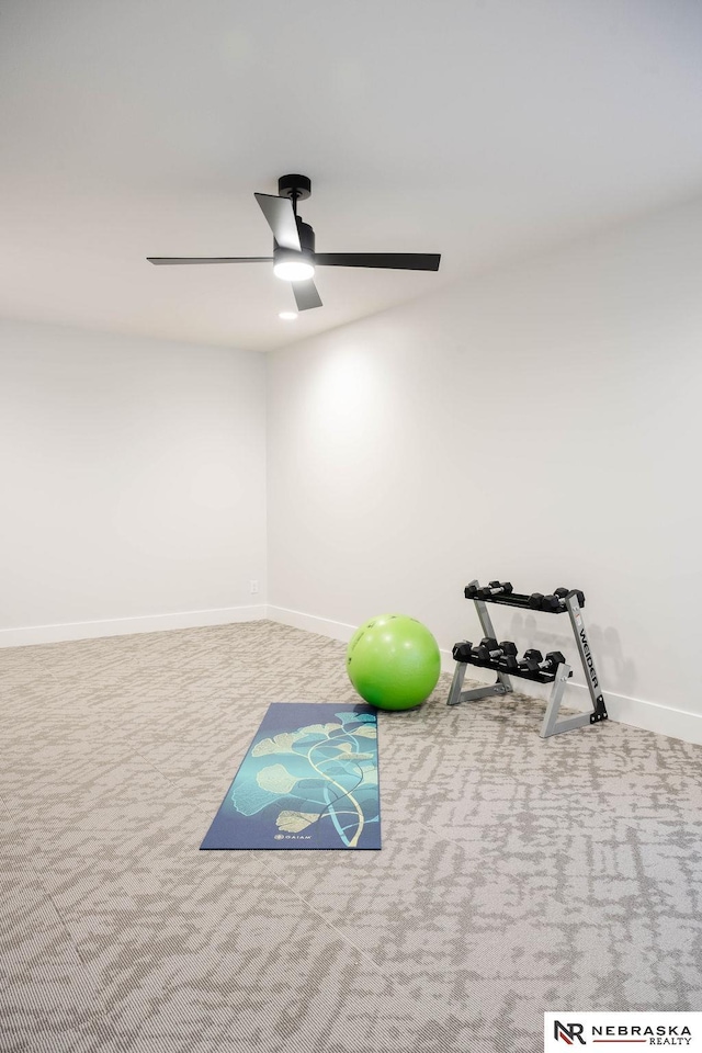 workout room with ceiling fan, baseboards, and carpet