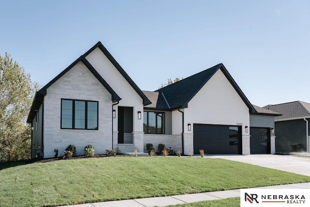 view of front of property with driveway, stone siding, a front yard, and an attached garage