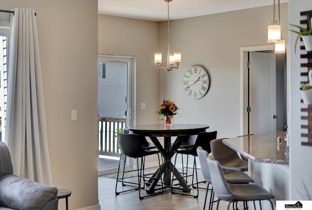 dining room with an inviting chandelier and wood finished floors