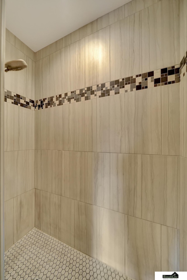 bathroom with a tile shower