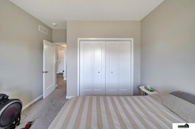 bedroom featuring a closet, baseboards, visible vents, and carpet floors