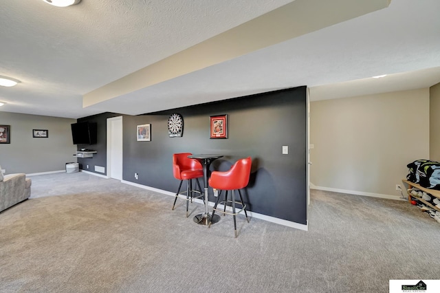 bar with baseboards, a textured ceiling, and carpet