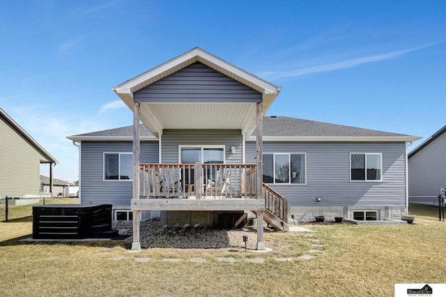 back of house featuring a shingled roof, fence, stairway, a deck, and a yard