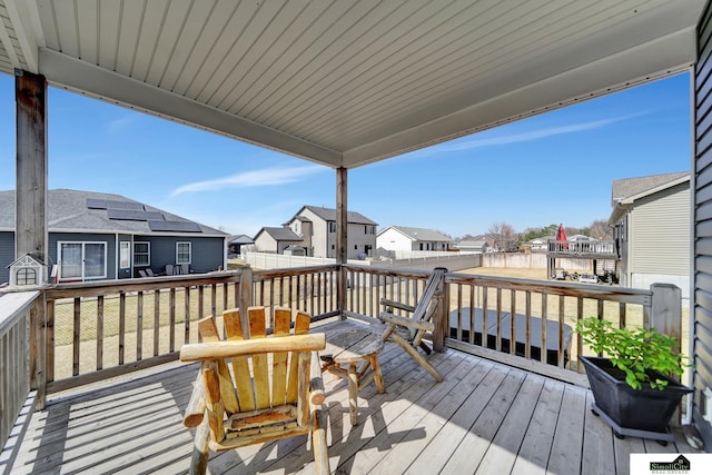 wooden deck featuring a residential view and fence