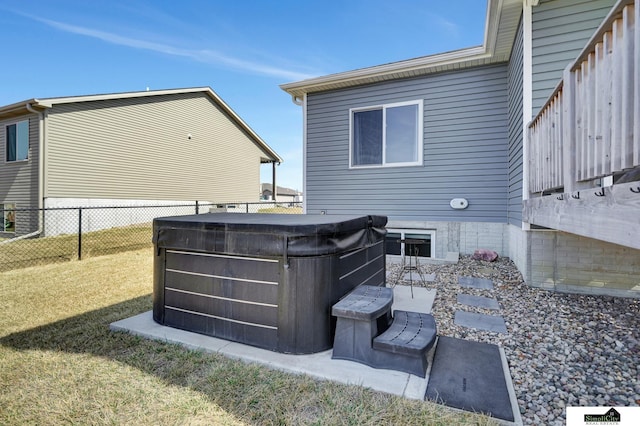 exterior space with fence and a hot tub