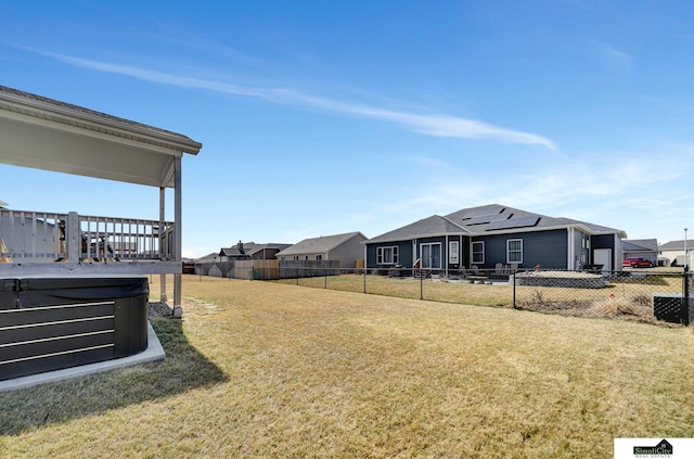 view of yard featuring a hot tub and fence