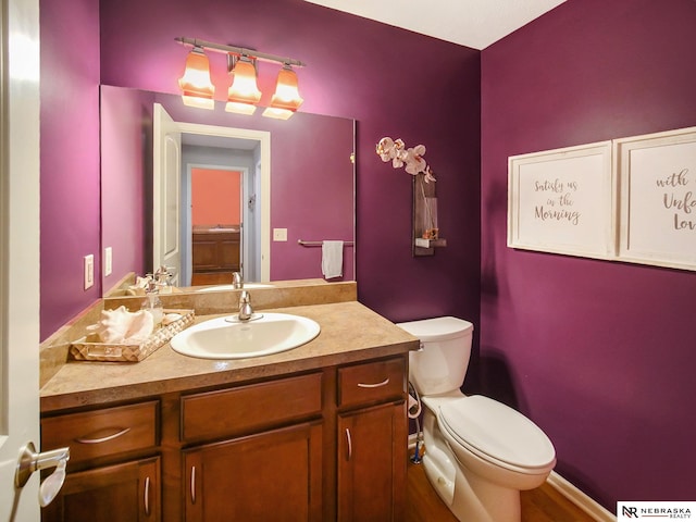 bathroom featuring toilet and vanity