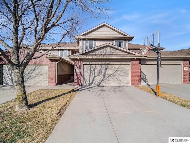 view of front of home featuring brick siding, concrete driveway, and an attached garage