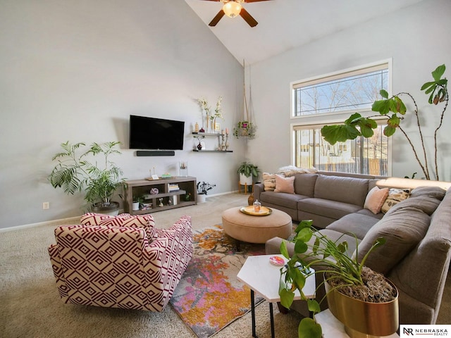 carpeted living room with baseboards, high vaulted ceiling, and ceiling fan