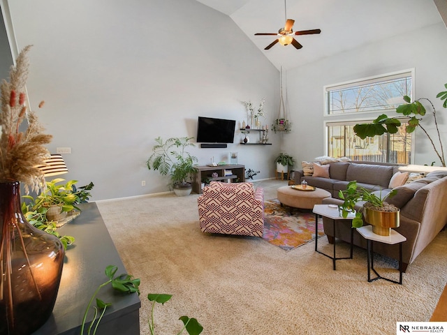 carpeted living area with baseboards, high vaulted ceiling, and ceiling fan