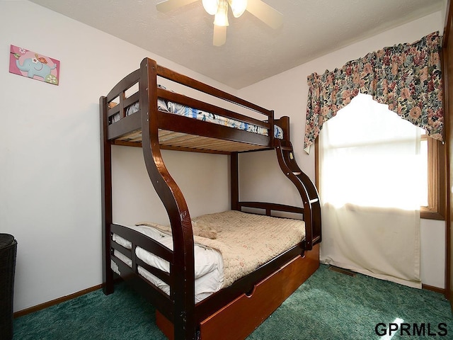 carpeted bedroom with baseboards and a ceiling fan