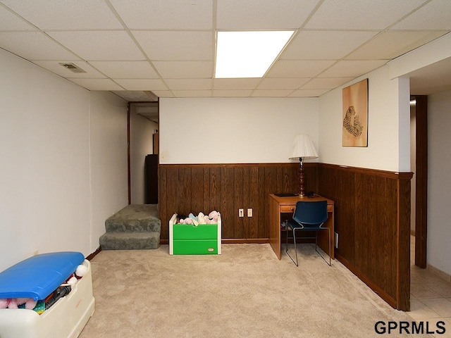 playroom with visible vents, a paneled ceiling, wooden walls, and wainscoting