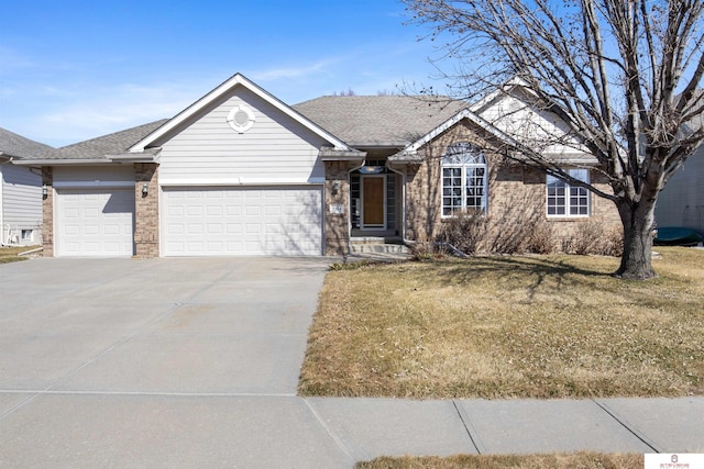 ranch-style home featuring concrete driveway, an attached garage, a front lawn, and a shingled roof