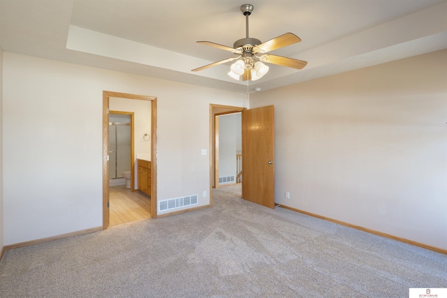 unfurnished bedroom with visible vents, baseboards, and light carpet