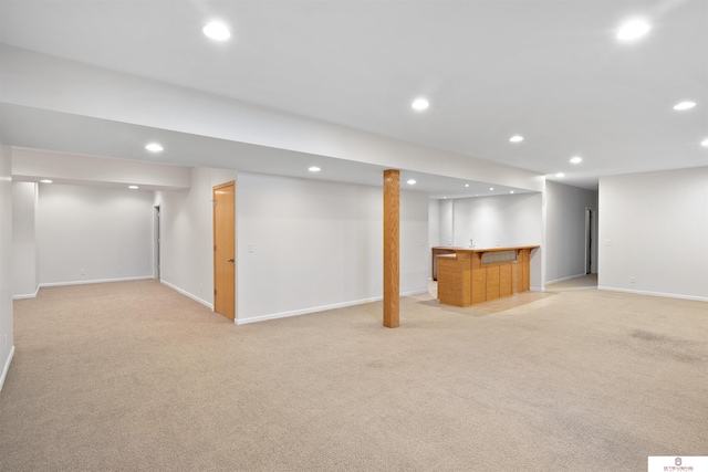 finished below grade area with recessed lighting, indoor wet bar, baseboards, and light colored carpet