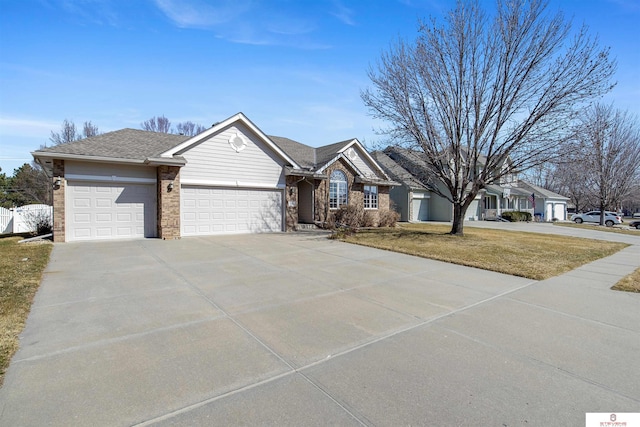 ranch-style home with brick siding, an attached garage, concrete driveway, and a front lawn